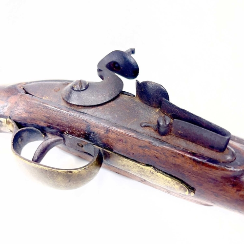 31 - A brass mounted flintlock pistol. Circa 1800, with proof marks to the barrel and brass butt cap and ... 