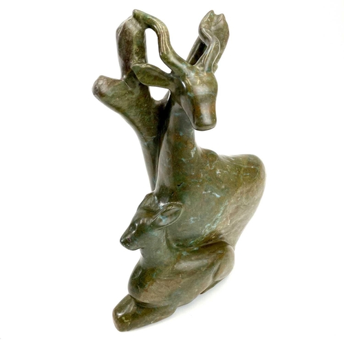 312 - An African carved green stone figure of a deer. Height 38cm.