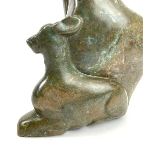 312 - An African carved green stone figure of a deer. Height 38cm.