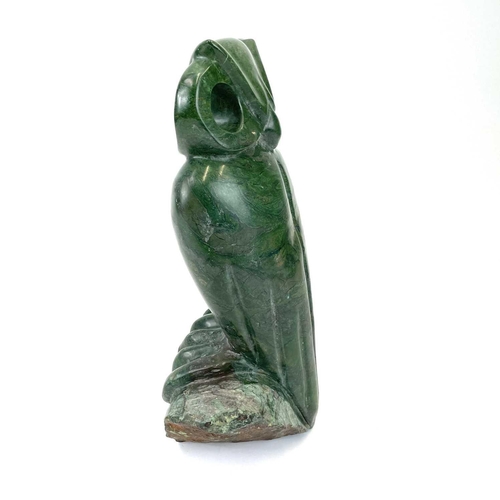 313 - An African green stone carving of an owl, Signed G Carimari. Double sided, with rough hewn base, hei... 