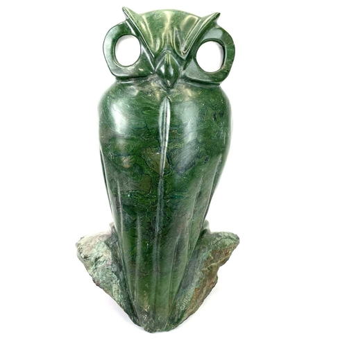 313 - An African green stone carving of an owl, Signed G Carimari. Double sided, with rough hewn base, hei... 