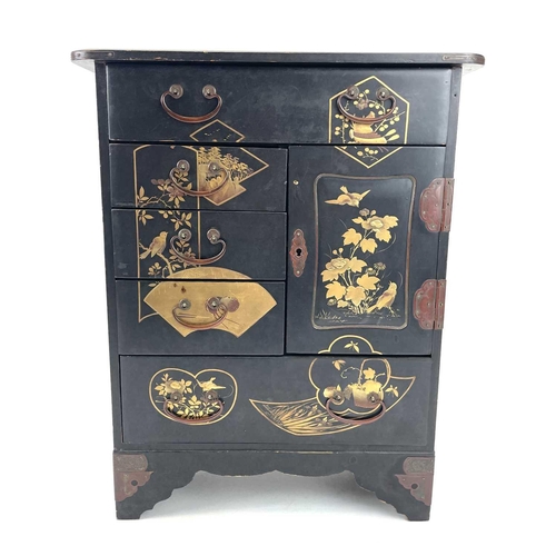 318 - A Japanese black lacquered small cabinet. Circa 1920, with gilt decoration and fitted a door and an ... 