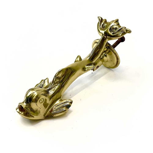 34 - A Victorian brass dolphin door knocker. Height 23cm, with turned stud.