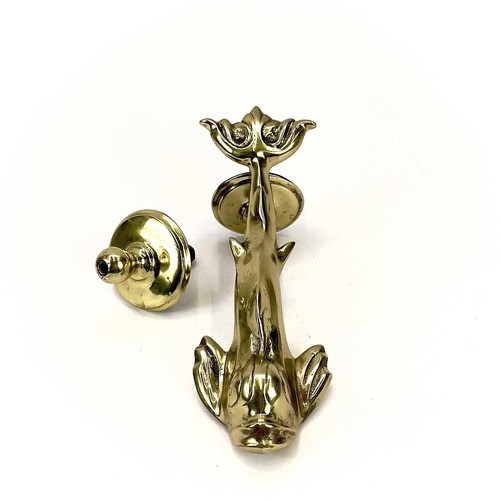 34 - A Victorian brass dolphin door knocker. Height 23cm, with turned stud.