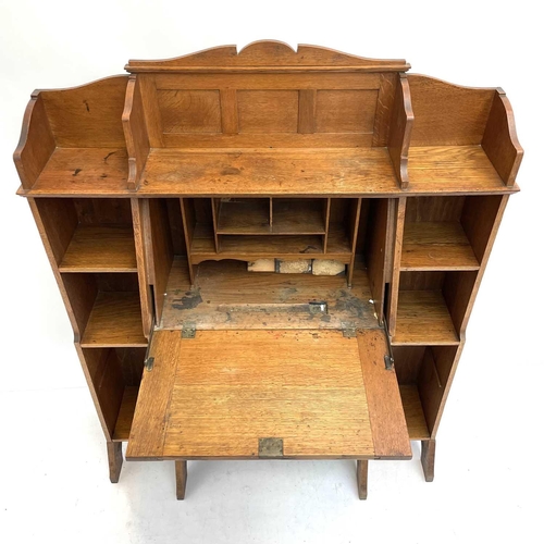 401 - An Arts and Crafts oak bureau cabinet. Circa 1900, the central fall with brass hinges and handle pie... 