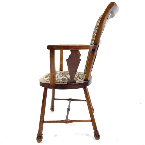 407 - An Arts and Crafts walnut and beech elbow chair. With padded back and seat and heart and lozenge inl... 