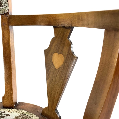 407 - An Arts and Crafts walnut and beech elbow chair. With padded back and seat and heart and lozenge inl... 