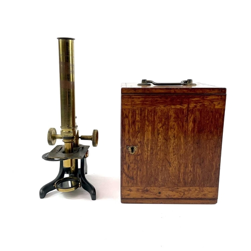 41 - A late Victorian brass microscope. Contained in a mahogany box, height 24cm.