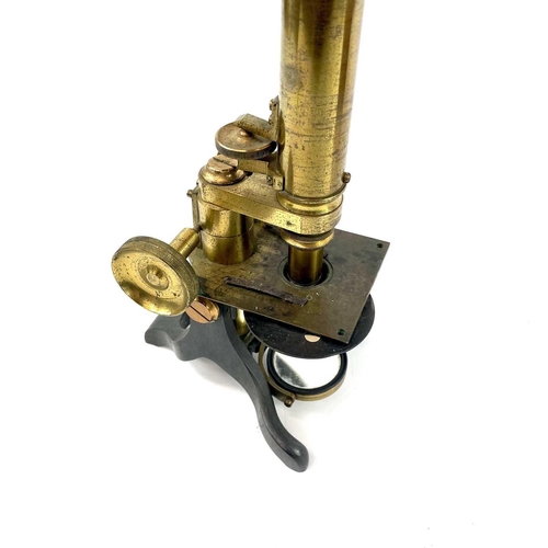 41 - A late Victorian brass microscope. Contained in a mahogany box, height 24cm.