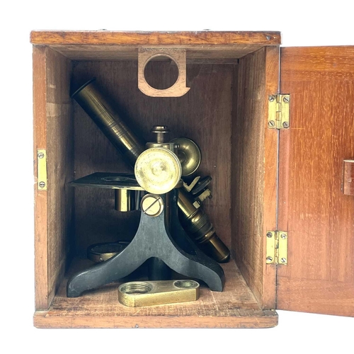 41 - A late Victorian brass microscope. Contained in a mahogany box, height 24cm.