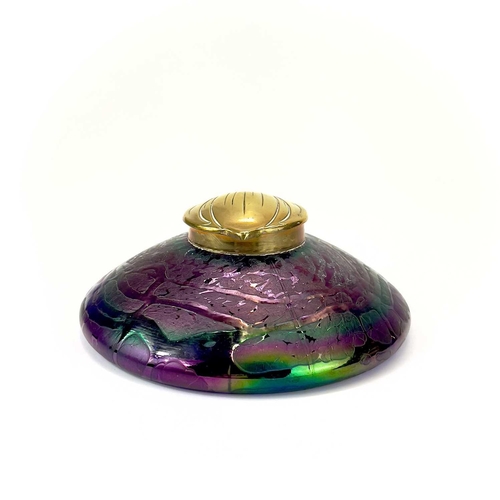 413 - An Art Nouveau Loetz type iridescent circular glass inkwell. With trailed decoration and embossed br... 