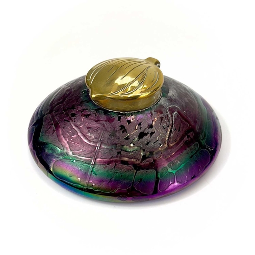 413 - An Art Nouveau Loetz type iridescent circular glass inkwell. With trailed decoration and embossed br... 