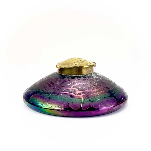 413 - An Art Nouveau Loetz type iridescent circular glass inkwell. With trailed decoration and embossed br... 