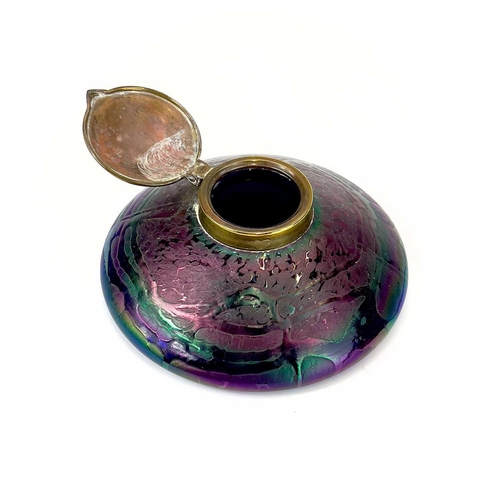 413 - An Art Nouveau Loetz type iridescent circular glass inkwell. With trailed decoration and embossed br... 