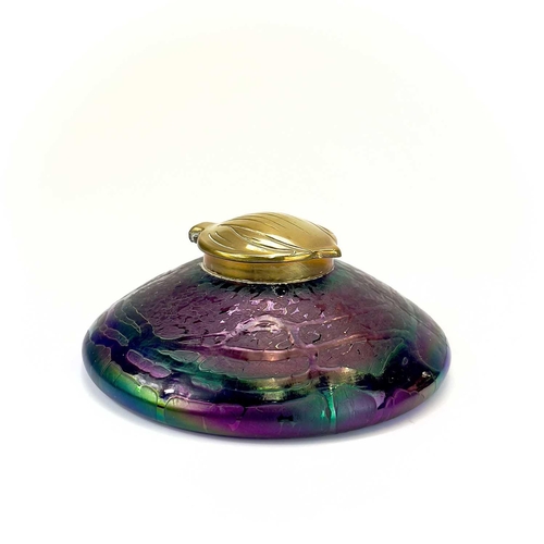 413 - An Art Nouveau Loetz type iridescent circular glass inkwell. With trailed decoration and embossed br... 