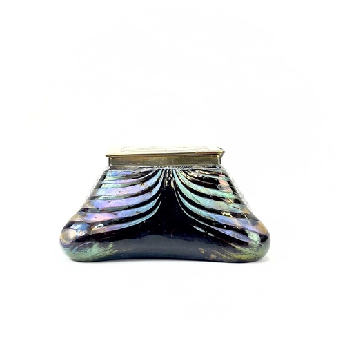 415 - An iridescent glass inkwell, probably Loetz. The lozenge shape brass cover inlaid in copper with ber... 