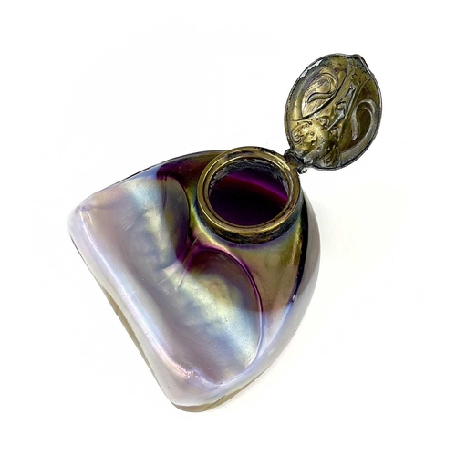 416 - An unusual iridescent glass inkwell. The opaque white and red blown glass body incorporating a pen r... 