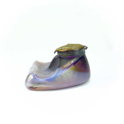 416 - An unusual iridescent glass inkwell. The opaque white and red blown glass body incorporating a pen r... 