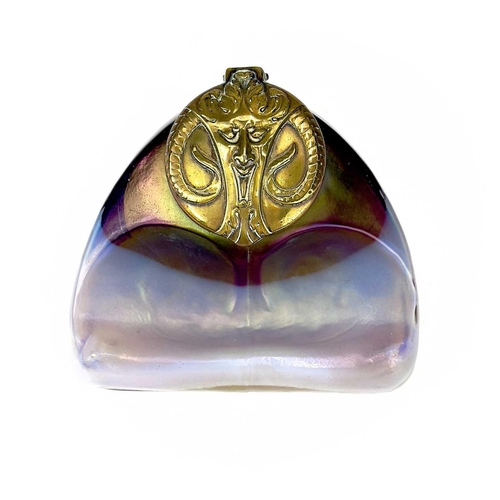 416 - An unusual iridescent glass inkwell. The opaque white and red blown glass body incorporating a pen r... 