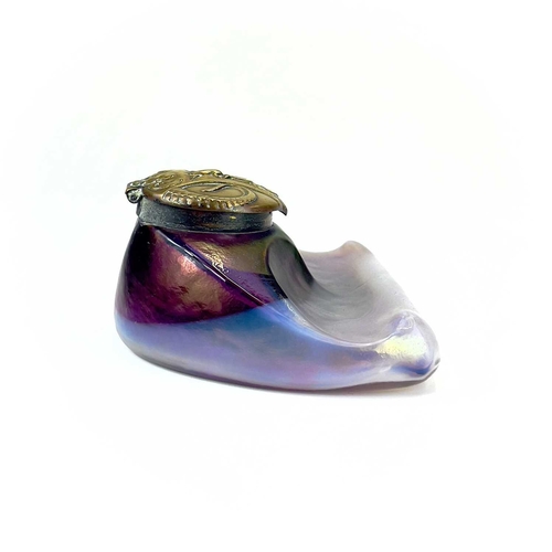 416 - An unusual iridescent glass inkwell. The opaque white and red blown glass body incorporating a pen r... 