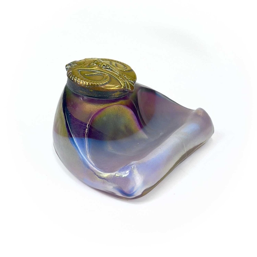 416 - An unusual iridescent glass inkwell. The opaque white and red blown glass body incorporating a pen r... 