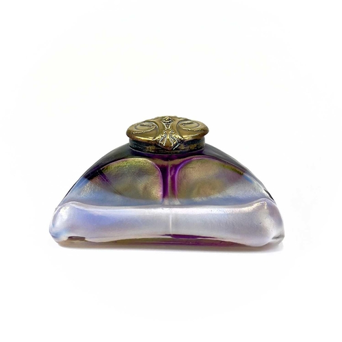 416 - An unusual iridescent glass inkwell. The opaque white and red blown glass body incorporating a pen r... 