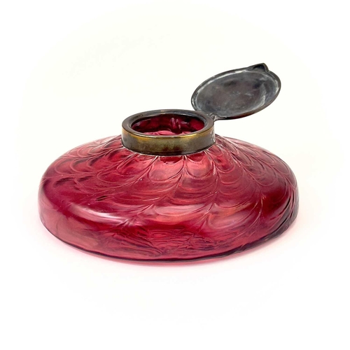 418 - A circular ruby glass inkwell, probably Kralik. With a web of trailed decoration and embossed brass ... 