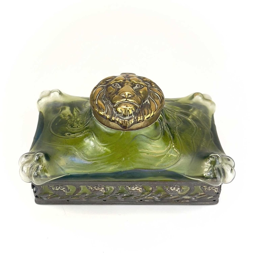 419 - A remarkable iridescent glass inkwell, probably Loetz. The brass cover embossed with a lion mask, th... 