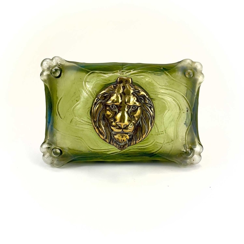 419 - A remarkable iridescent glass inkwell, probably Loetz. The brass cover embossed with a lion mask, th... 