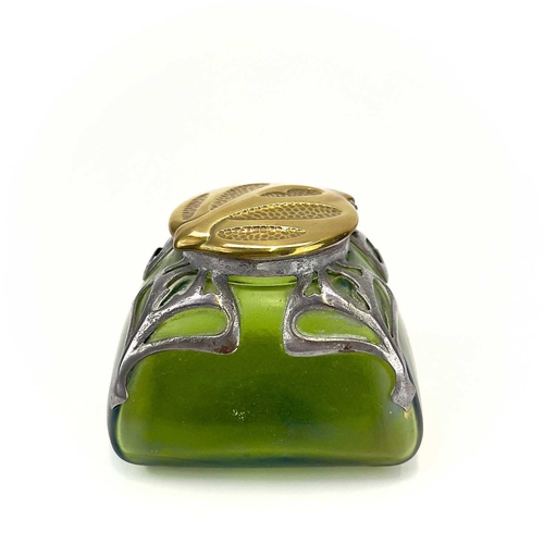 420 - An Art Nouveau iridescent green glass inkwell. Of square section, with embossed brass cover and pier... 