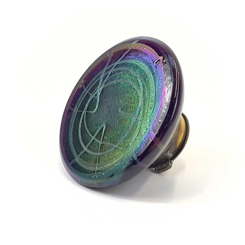 421 - A Loetz type iridescent glass circular inkwell. With trailed decoration and brass cover, height 6.5c... 