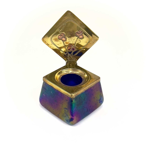 422 - A Loetz type iridescent glass inkwell. Of lozenge shape, the brass cover with copper inset fruiting ... 