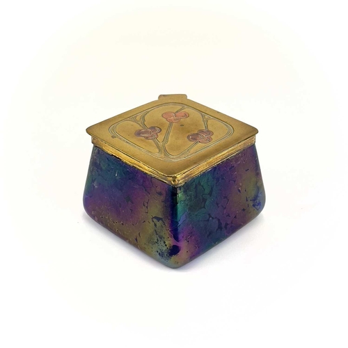 422 - A Loetz type iridescent glass inkwell. Of lozenge shape, the brass cover with copper inset fruiting ... 