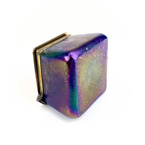 422 - A Loetz type iridescent glass inkwell. Of lozenge shape, the brass cover with copper inset fruiting ... 