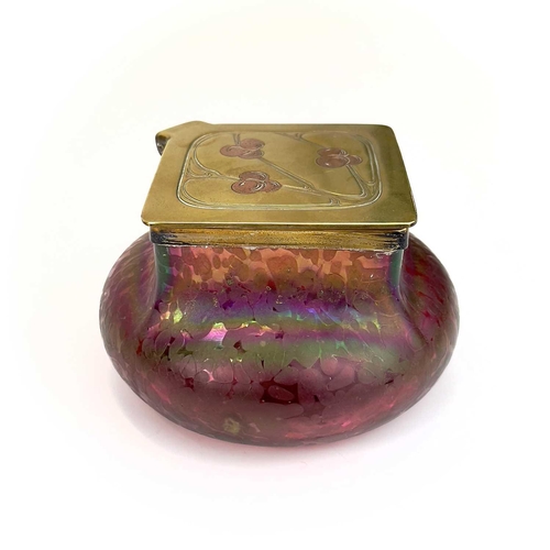 423 - A Loetz type ruby iridescent glass inkwell. The lozenge shaped brass cover inset with copper berries... 