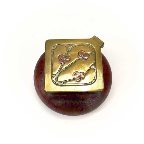 423 - A Loetz type ruby iridescent glass inkwell. The lozenge shaped brass cover inset with copper berries... 