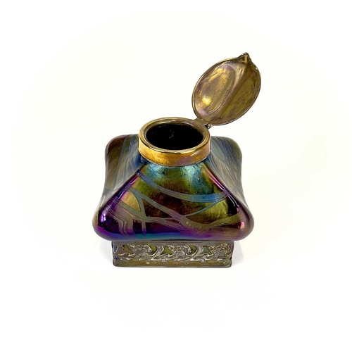 424 - An iridescent glass inkwell, probably Loetz. Of lobed square form with typical trailed decoration an... 