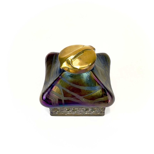 424 - An iridescent glass inkwell, probably Loetz. Of lobed square form with typical trailed decoration an... 