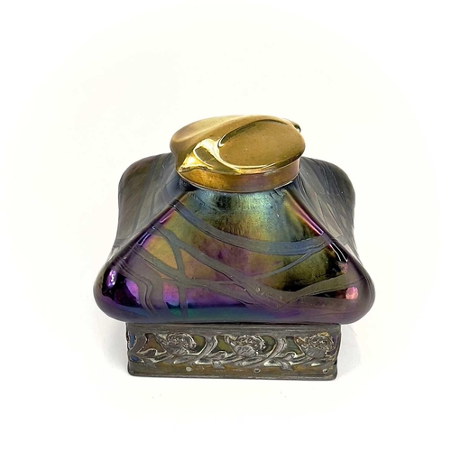 424 - An iridescent glass inkwell, probably Loetz. Of lobed square form with typical trailed decoration an... 