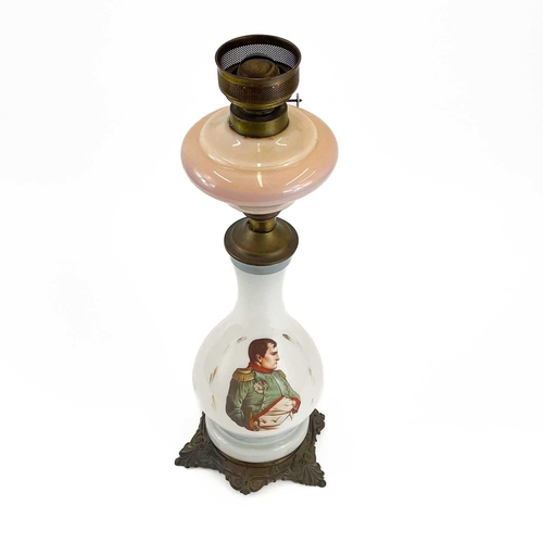 44 - A French opaque glass oil lamp. Circa 1900, printed with a portrait of Napoleon, on a gilt metal bas... 