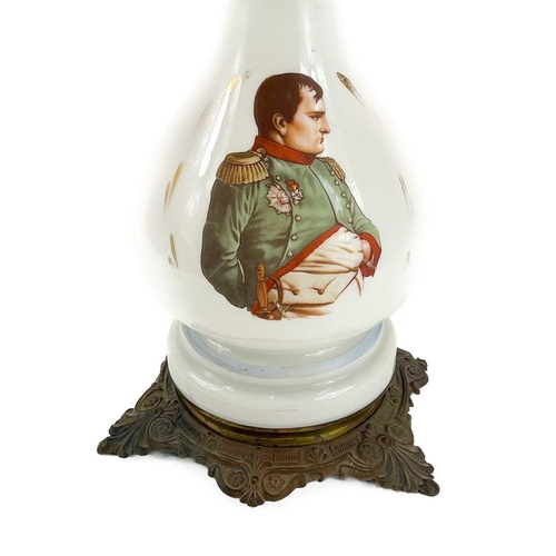 44 - A French opaque glass oil lamp. Circa 1900, printed with a portrait of Napoleon, on a gilt metal bas... 