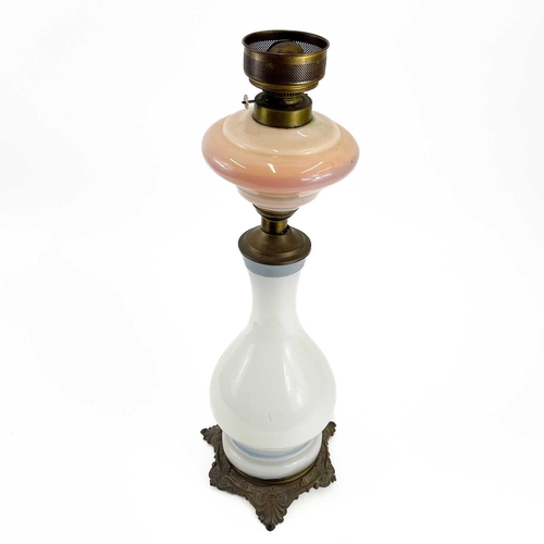 44 - A French opaque glass oil lamp. Circa 1900, printed with a portrait of Napoleon, on a gilt metal bas... 