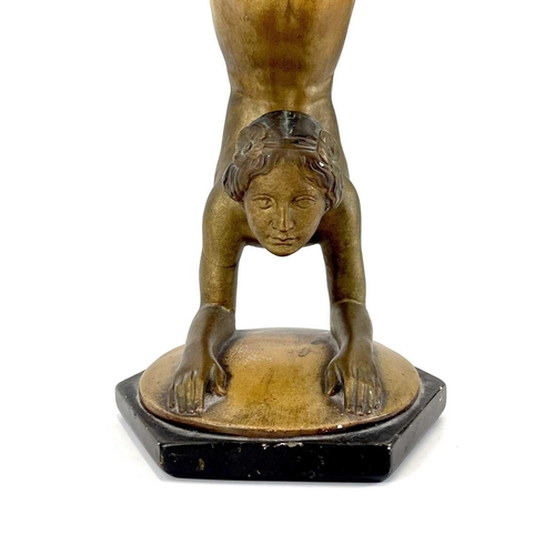 453 - An Art Deco bronze painted plaster figure of a female acrobat. Stamped O P 406 RD825881, height 45cm... 