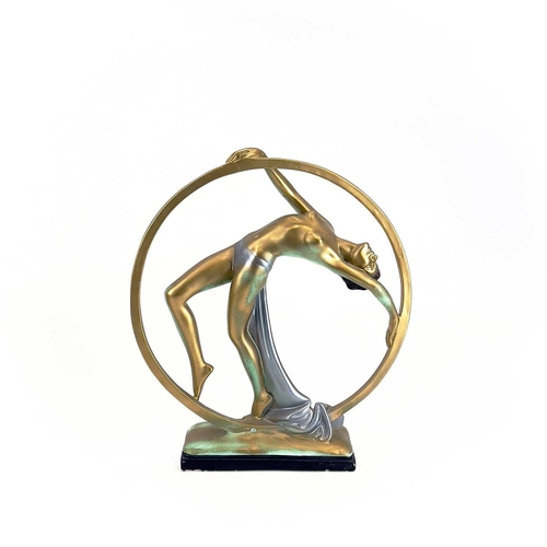 454 - An Art Deco cast plaster figure. Of a female dancing within a hoop. Height 37cm.