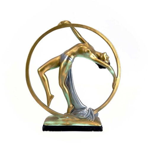 454 - An Art Deco cast plaster figure. Of a female dancing within a hoop. Height 37cm.