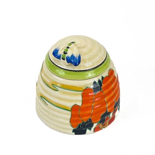 458 - A Clarice Cliff Fantastique beehive honey pot and cover. Decorated in the solitude pattern with appl... 