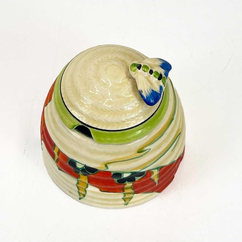 458 - A Clarice Cliff Fantastique beehive honey pot and cover. Decorated in the solitude pattern with appl... 