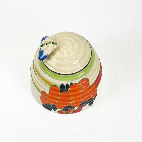 458 - A Clarice Cliff Fantastique beehive honey pot and cover. Decorated in the solitude pattern with appl... 