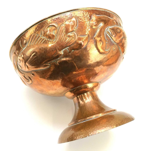 5 - A Newlyn copper rose bowl. Repousse decorated with a band of four fish and seaweed, on a pedestal fo... 