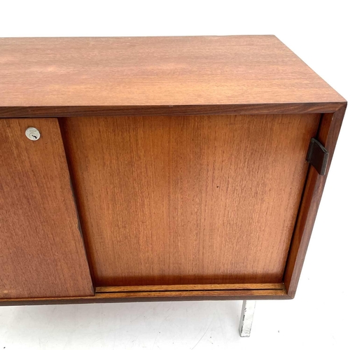 509 - A mid-century teak side cabinet. Fitted two sliding doors and raised on square metal legs. Height 68... 